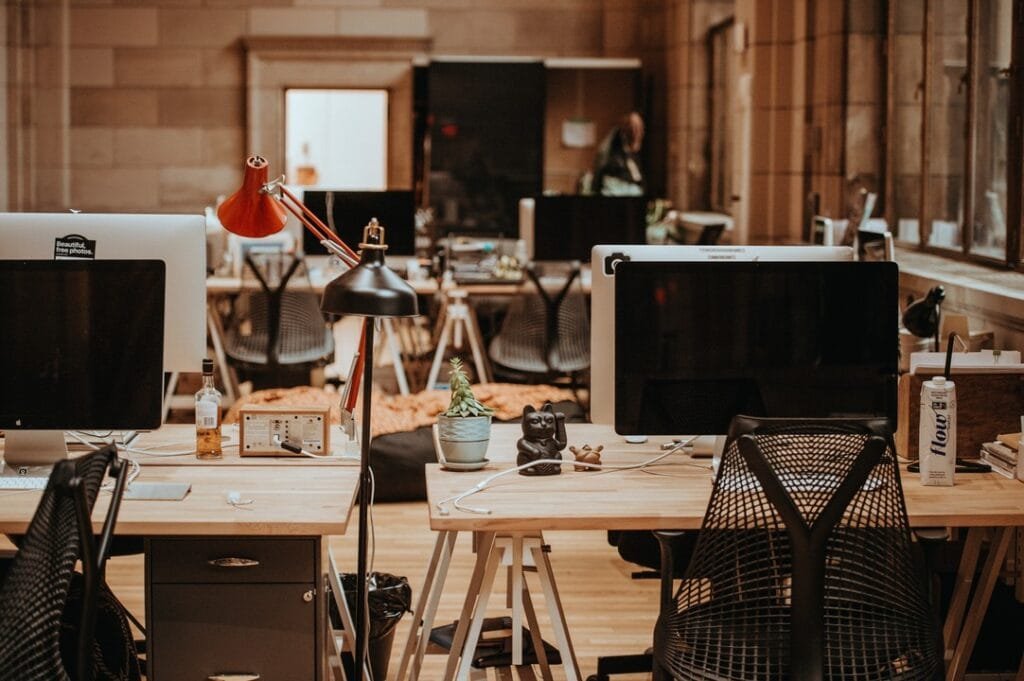 Modern office with Mac desktops and lamps