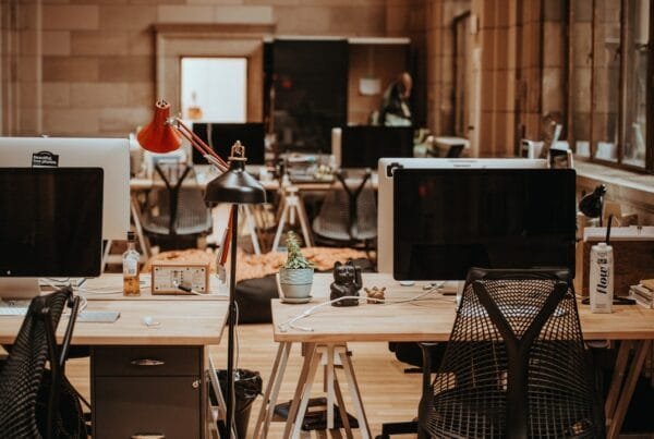 Modern office with Mac desktops and lamps