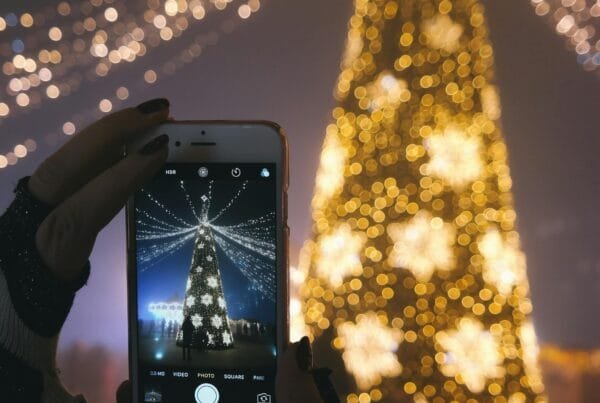 Taking a picture on of a Christmas tree.